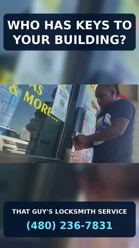 Commercial locksmith working on storefront door